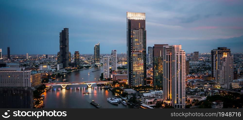 Night cityscape and high-rise buildings in metropolis city center . Downtown business district in panoramic view .. Night cityscape and high-rise buildings in metropolis city center