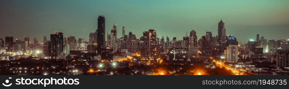 Night cityscape and high-rise buildings in metropolis city center . Downtown business district in panoramic view .. Night cityscape and high-rise buildings in metropolis city center