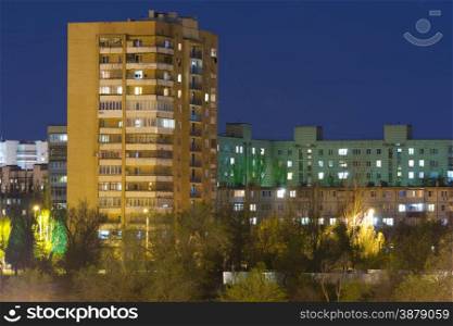 Night cityscape - high-rise building in the night sky and other high-rise buildings. High-rise building in the night sky