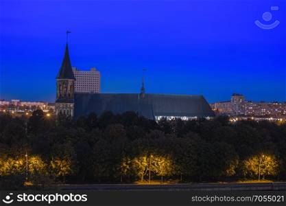 Night cityscape of Kaliningrad, Russia. Gothic cathedral in Kaliningrad city, formerly Koenigsberg, Germany. Beautiful view of Kant Island. Night illumination. The center of city in evening. Night cityscape of Kaliningrad, Russia