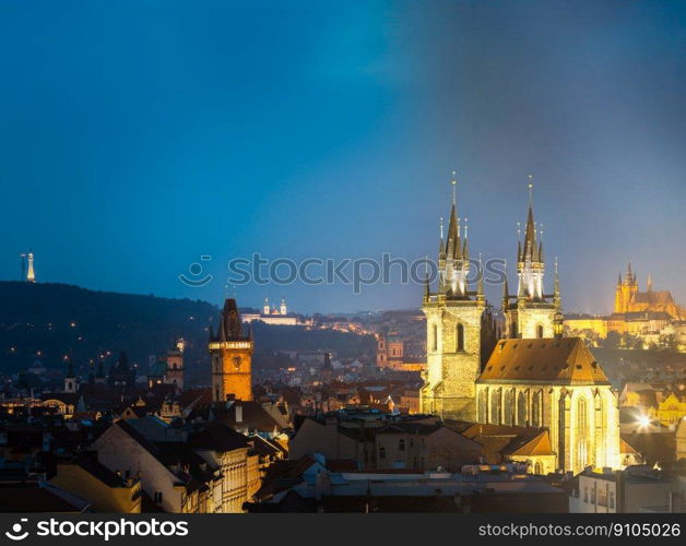 Night cityscape of Prague, Czech Republic. Famous Old town hall, Church Of Our Lady Before Tyn, St. Vitus Cathedral. Night cityscape of Prague, Czech Republic. Town hall, Church Of Our Lady Before Tyn, St. Vitus Cathedral