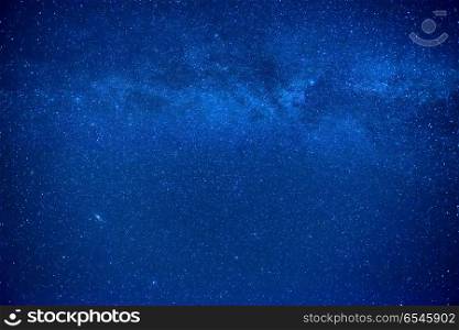 Night dark blue sky with many stars and milky way galaxy. Night dark blue sky