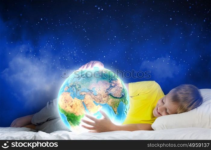 Night dreaming. Cute boy sleeping in bed holding Earth planet. Elements of this image are furnished by NASA