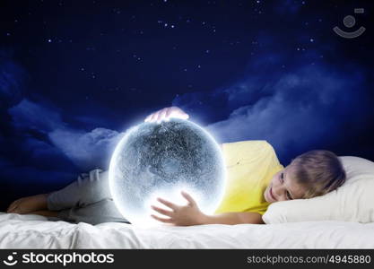 Night dreaming. Cute boy sleeping in bed with moon