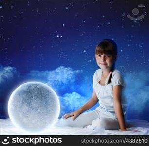 Night dreaming. Cute girl sitting in bed with moon