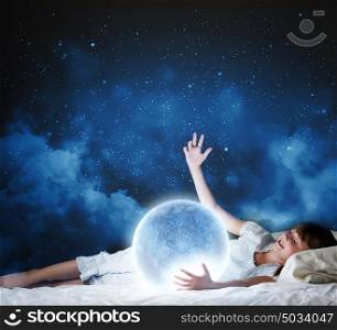 Night dreaming. Cute girl sleeping in bed with moon