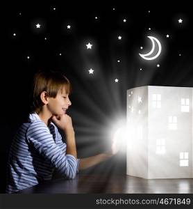 Night dreaming. Cute little boy in dark room dreaming about home and family
