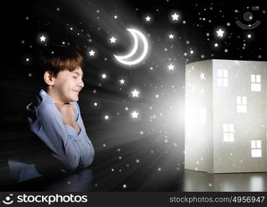 Night dreaming. Cute little boy in dark room dreaming about home and family