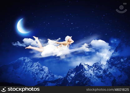 Night dreaming. Young blond girl flying in night sky