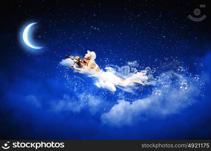 Night dreaming. Young blond girl flying in night sky