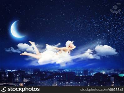 Night dreaming. Young blond girl flying in night sky