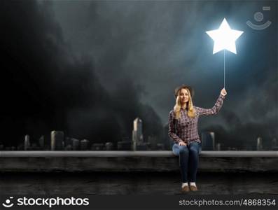 Night dreaming. Young woman in casual with balloon shaped like star