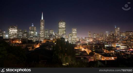 Night falls over the recognizable downtown skyline of San Francisco
