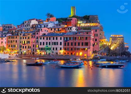 Night fishing village Vernazza with lookout tower of Doria Castle to protect the village from pirates, Five lands, Cinque Terre National Park, Liguria, Italy.