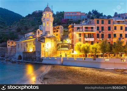 Night fishing village Vernazza with Santa Margherita di Antiochia Church, Five lands, Cinque Terre National Park, Liguria, Italy.