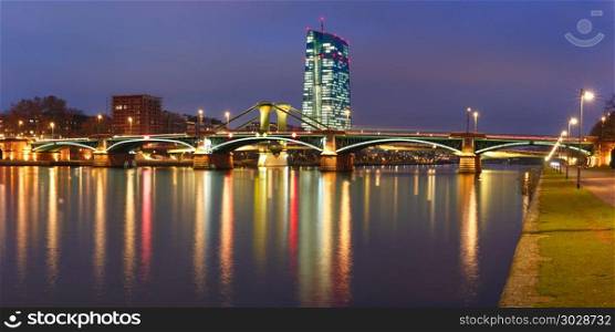 Night Frankfurt am Main, Germany. Picturesque panoramic view of Frankfurt am Main skyline during evening blue hour with mirror reflections in the river, Germany