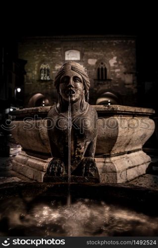 Night image of the fountain detail of Piazza Vecchia, the Sphinx of the Contarini fountain in the center of the square in Bergamo Alta, historic city of Lombardy