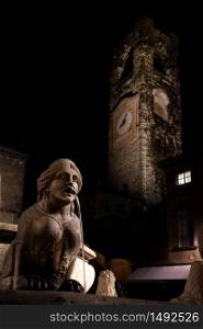 Night image of the fountain in Piazza Vecchia, the Sphinx of the Contarini fountain in the center of the square in Bergamo Alta, in the background the Civic Tower also called Campanone