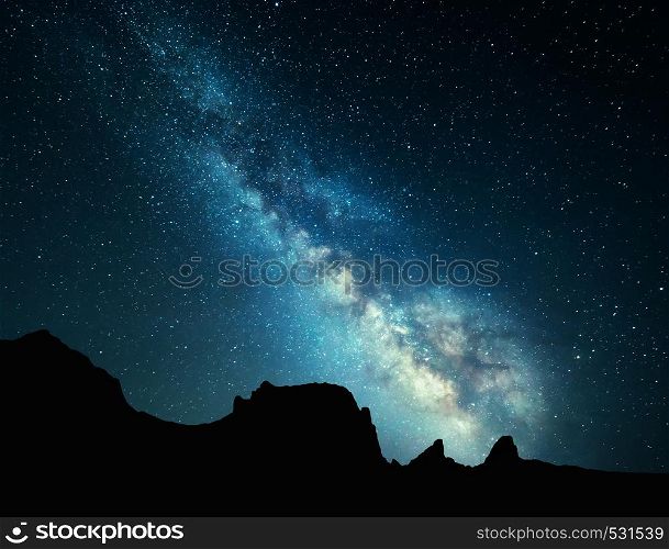 Night landscape with colorful Milky Way at mountains. Starry sky with rocks at summer. Beautiful Universe