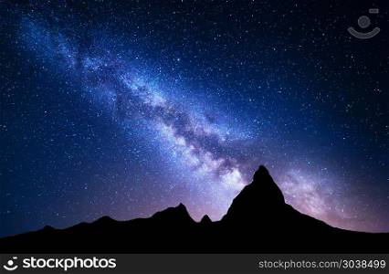 NIght landscape with Milky Way at mountains. NIght landscape with Milky Way at mountains. Night colorful scenery. Sky with stars at summer. Beautiful Universe. Space background with galaxy and high rocks. Blue milky way. Mountain valley