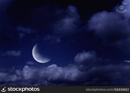Night landscape with the moon in a cloudy sky
