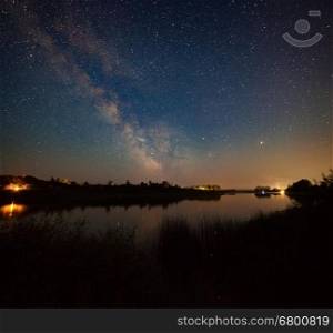 Night landscape with woods on river shore under starry sky, Don river, Russia