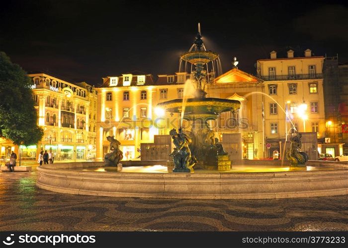 Night-lit fountain in Rossio Square, Lisbon, Portugal
