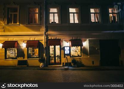 Night old house facade at the center of Vilnius with street lanterns