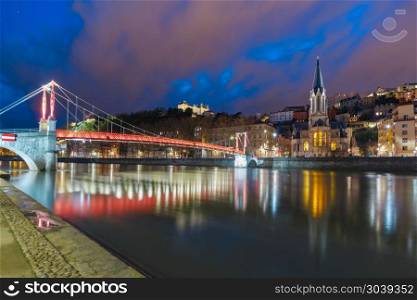 Night old town of Lyon, France. Panoramic view of Saint Georges church and footbridge across Saone river in the Old town during evening blue hour, Lyon, France