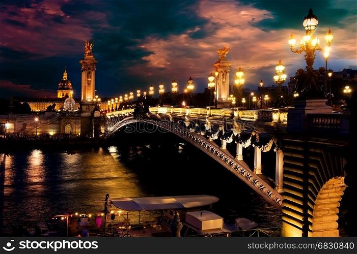 Night over Alexandre III bridge in Paris, France