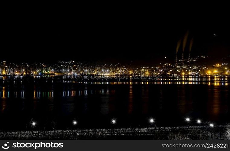 Night panoramic view of the port, cranes and other port infrastructure. Novorossiysk trading port on the Black Sea, Tsemesskaya bay