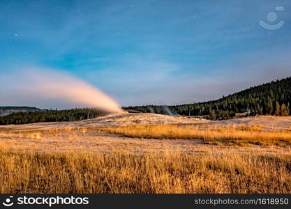 night photo os old faithful geisers in yellowstone national park