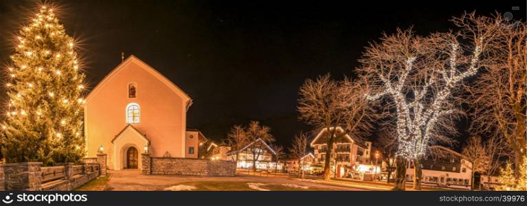 Night photography in the Ehrwald village, from Austria, during winter season, when all the buildings and trees are decorated with lights.