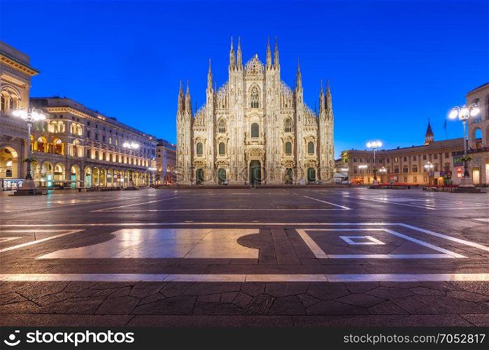 Night Piazza del Duomo in Milan, Italy. Piazza del Duomo, Cathedral Square, with Milan Cathedral or Duomo di Milano, Galleria Vittorio Emanuele II and Arengario, during morning blue hour, Milan, Lombardia, Italy