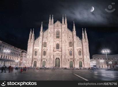 Night picture with the Cathedral of Milan, known also as the Duomo of Milan, with a beautiful sky full of stars and enlightened by the moon.