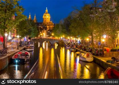 Night red-light district De Wallen, canal, Basilica of Saint Nicholas and bridge, Amsterdam, Holland, Netherlands. Long exposure.