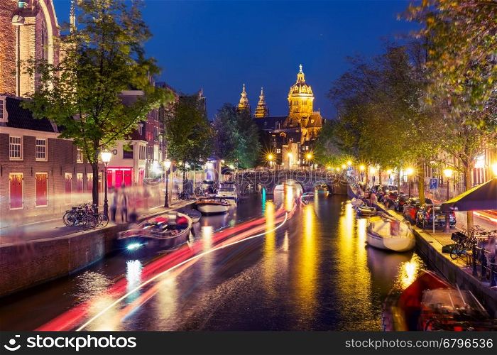 Night red-light district De Wallen, canal, Basilica of Saint Nicholas and bridge, Amsterdam, Holland, Netherlands. Long exposure. Used toning