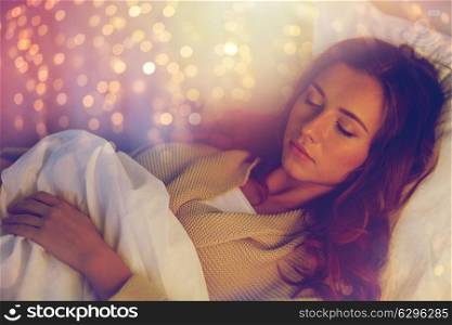 night, rest, comfort and people concept - young woman sleeping in bed at home. young woman sleeping in bed at home