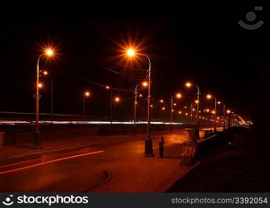 night road through bridge with street lamps
