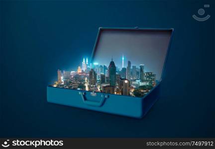 Night scene modern city in an open retro vintage suitcase isolated on blue background .