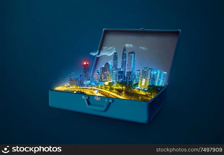 Night scene modern city skyscraper in an open retro vintage suitcase isolated on blue background .