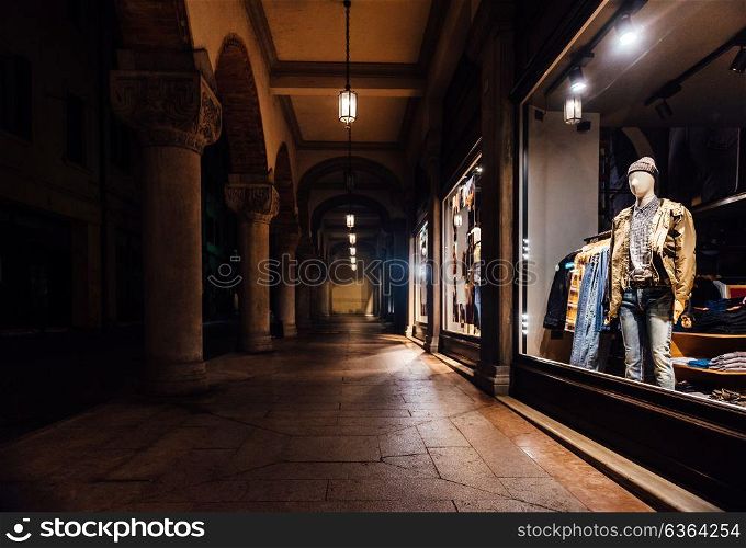 night shop window with clothes in italy