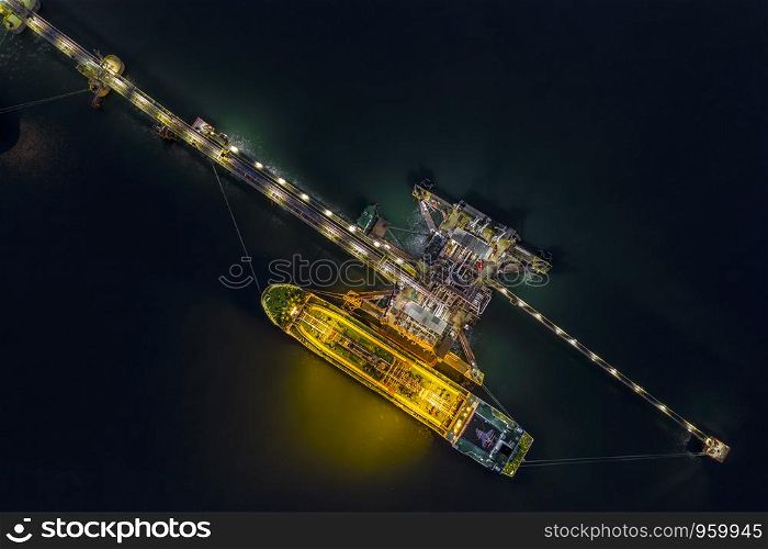 night shot oil tanker transport loading in oil station import and export business logistics transportation open sea top view
