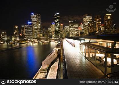 Night skyline with buildings and harbor in Sydney, Australia.