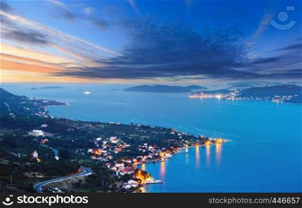 Night summer Croatian Peljesac peninsula (Viganj, Croatia) coastline, and Korcula village and island in far.