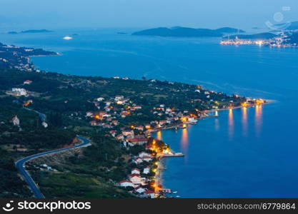 Night summer Croatian Peljesac peninsula (Viganj, Croatia) coastline, and Korcula village and island in far.