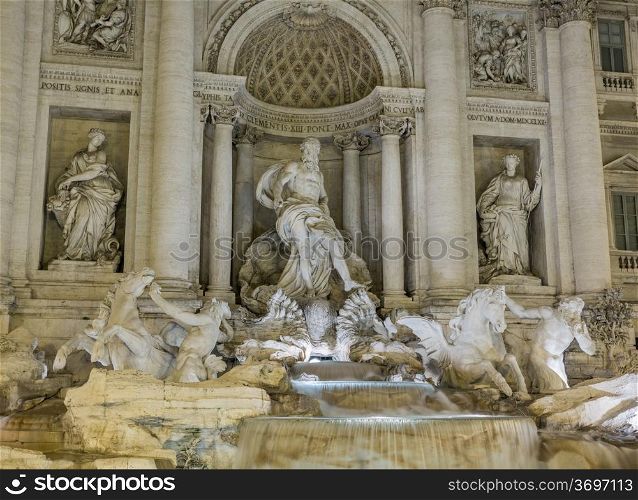 Night time floodlit details of statues in Trevi fountain in Rome Italy