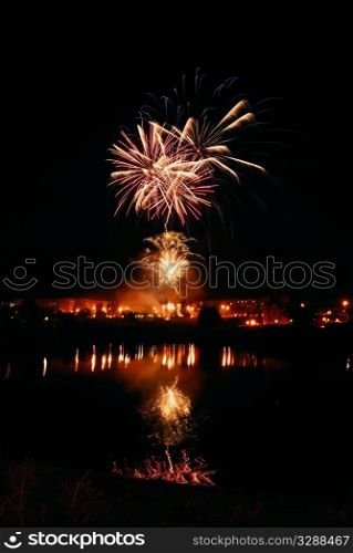 night traditional firework with reflection in water