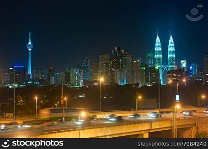 NIght traffic in Kuala Lumpur. Skyline of KL on the background. Malaysia