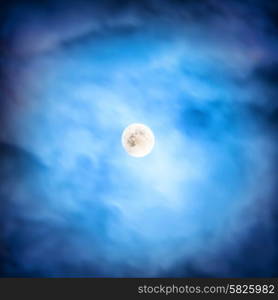 Night view at the full moon through moving orange clouds. Abstract scene